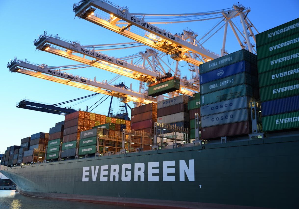 An Evergreen container ship loading at the Port of Baltimore during daytime.