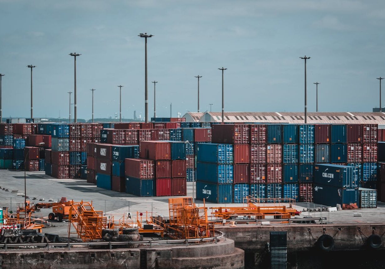 Colorful cargo containers stacked at a busy industrial port, showcasing global trade.