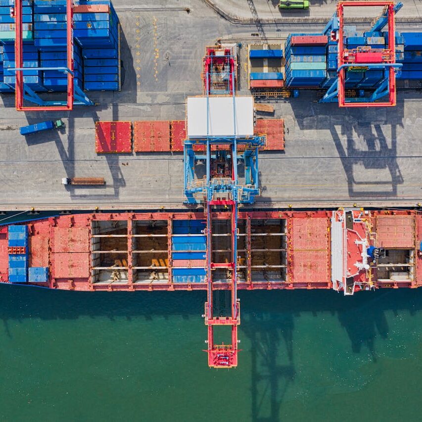 Drone shot of cargo ship and containers at North Jakarta port, illustrating trade and transportation.